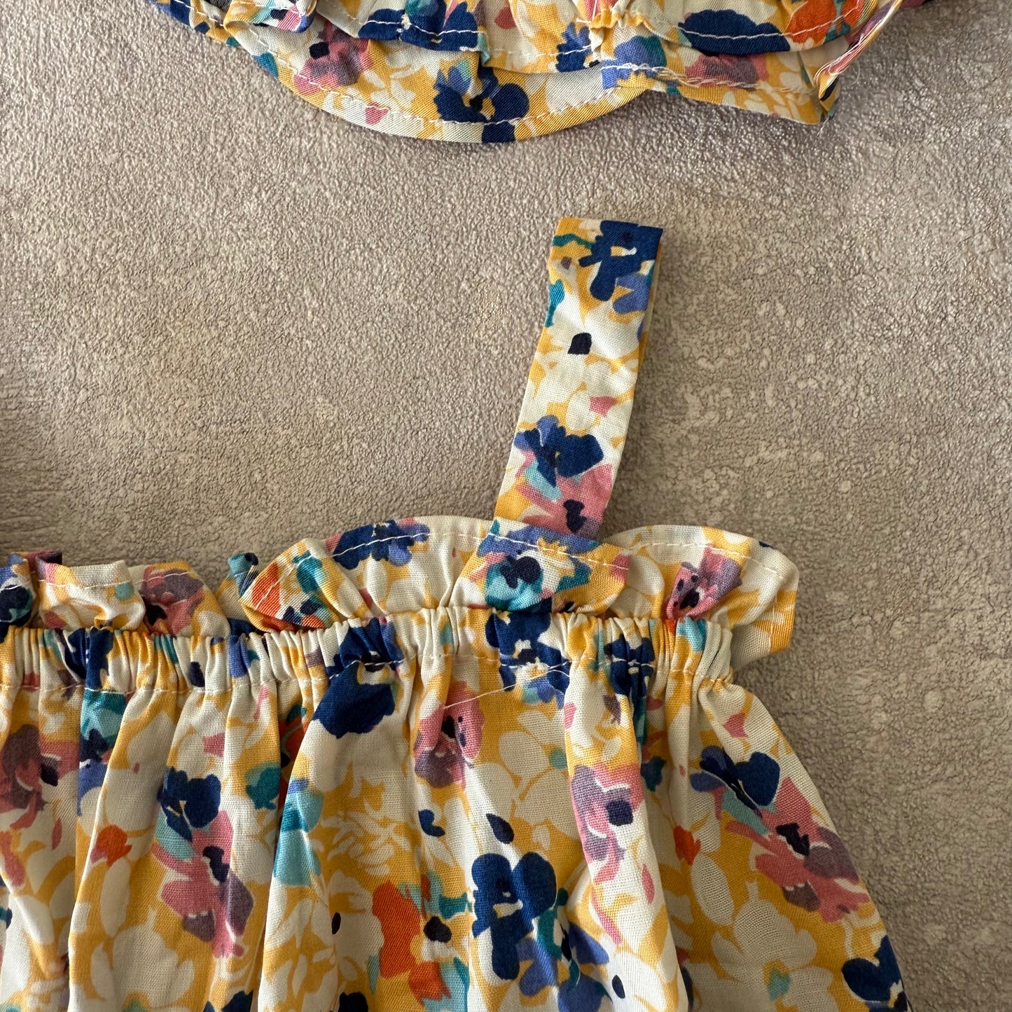 Blauw/geel bloemen rompertje