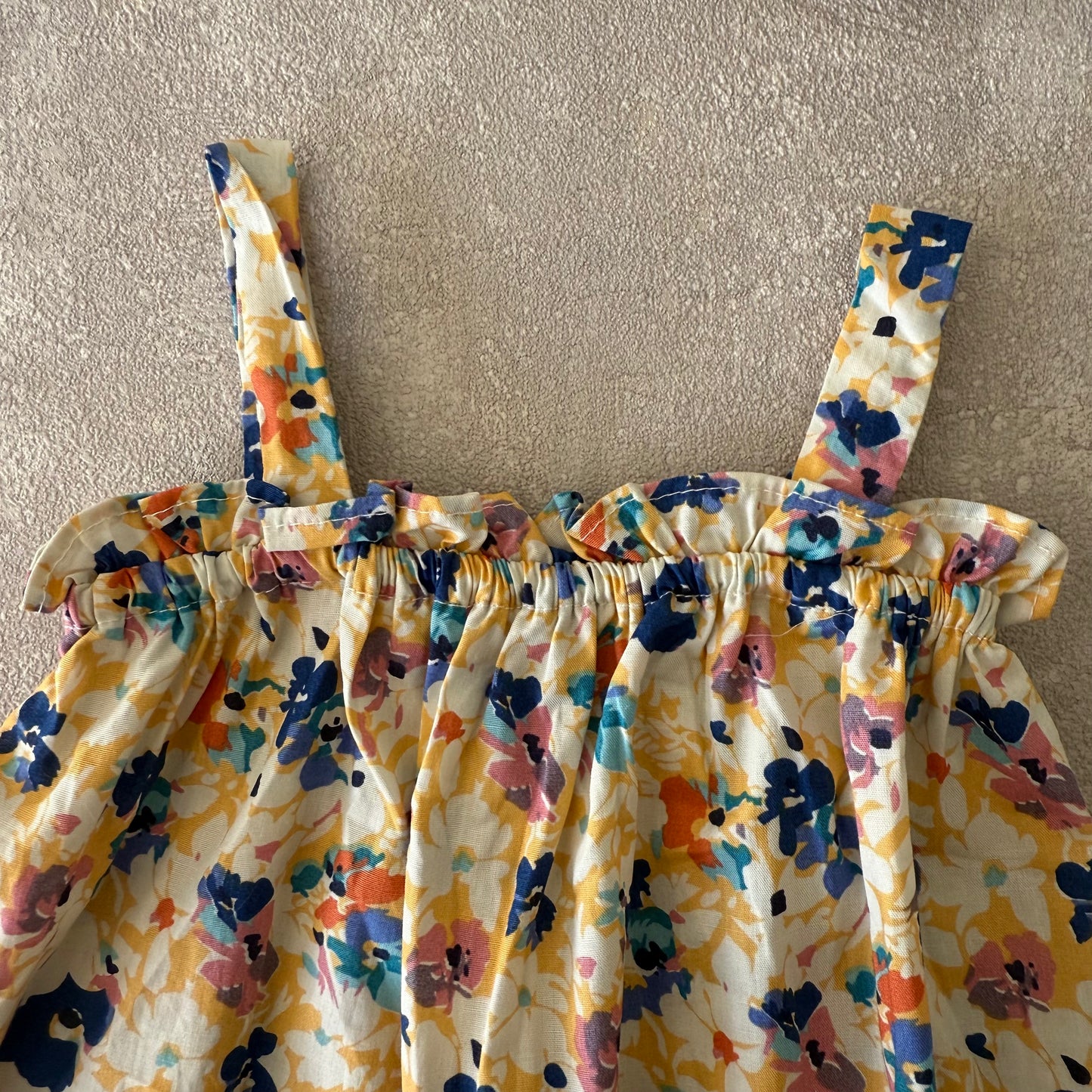 Blauw/geel bloemen rompertje